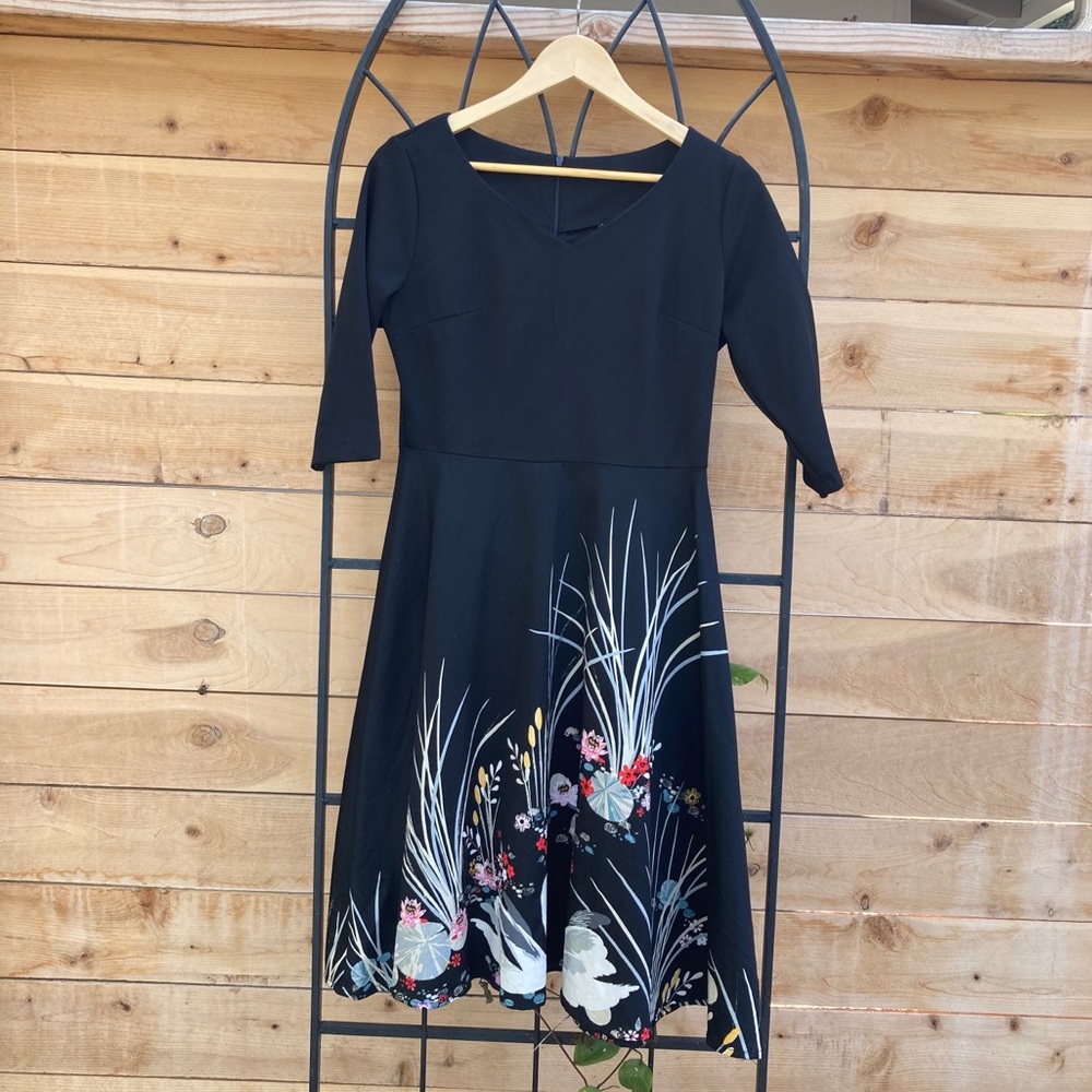 Vintage black v-neck dress with printed skirt.